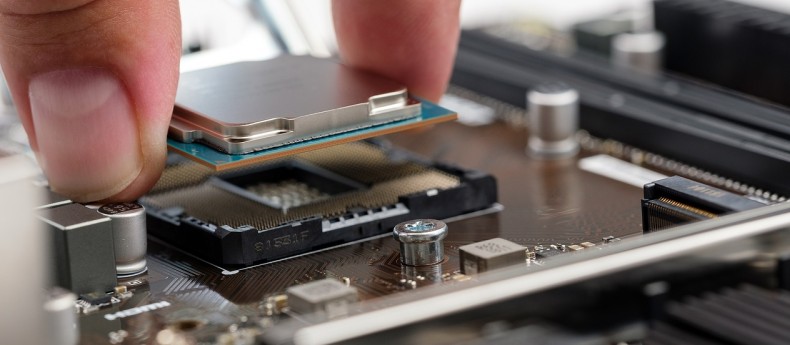 Buying a used cpu for gaming - Man carefully installing a CPU into a motherboard socket during a PC build