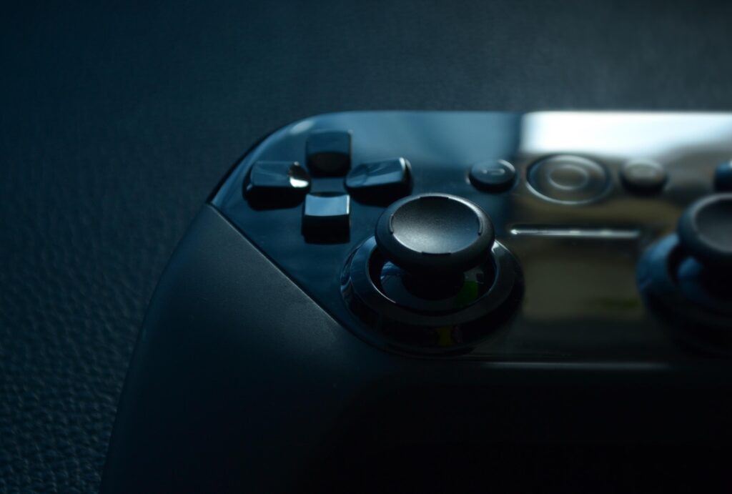 Image of a Play station controller on a leathery background.