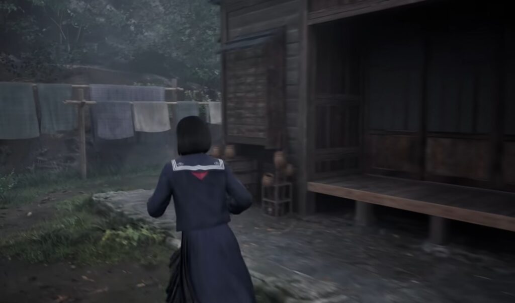 Girl running past a house in Silent Hill during a tense exploration sequence