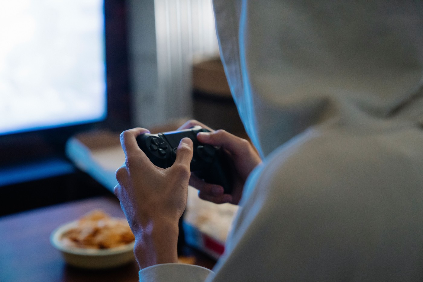 PC gamer using a controller while playing one of the best free controller games for PC on a gaming setup.